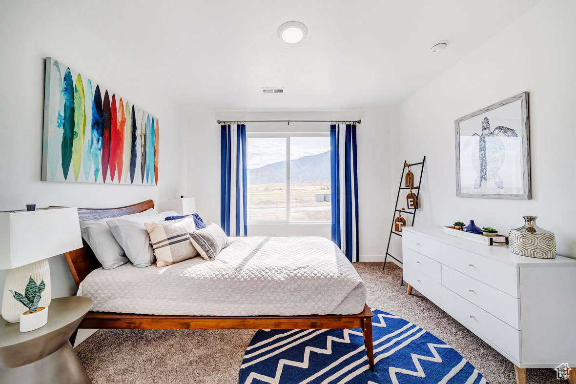 Bedroom with a mountain view and light carpet