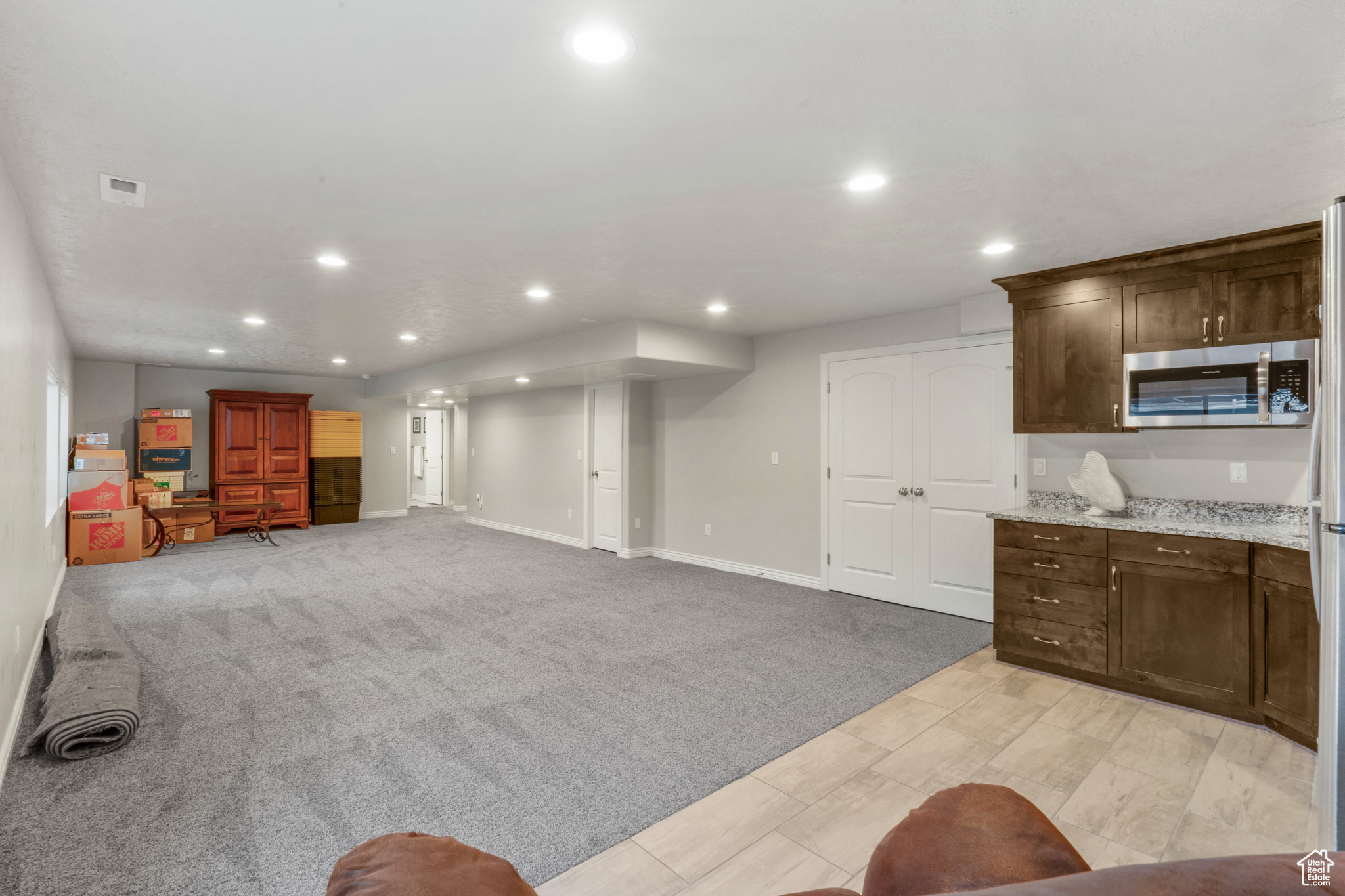 Unfurnished living room featuring light carpet