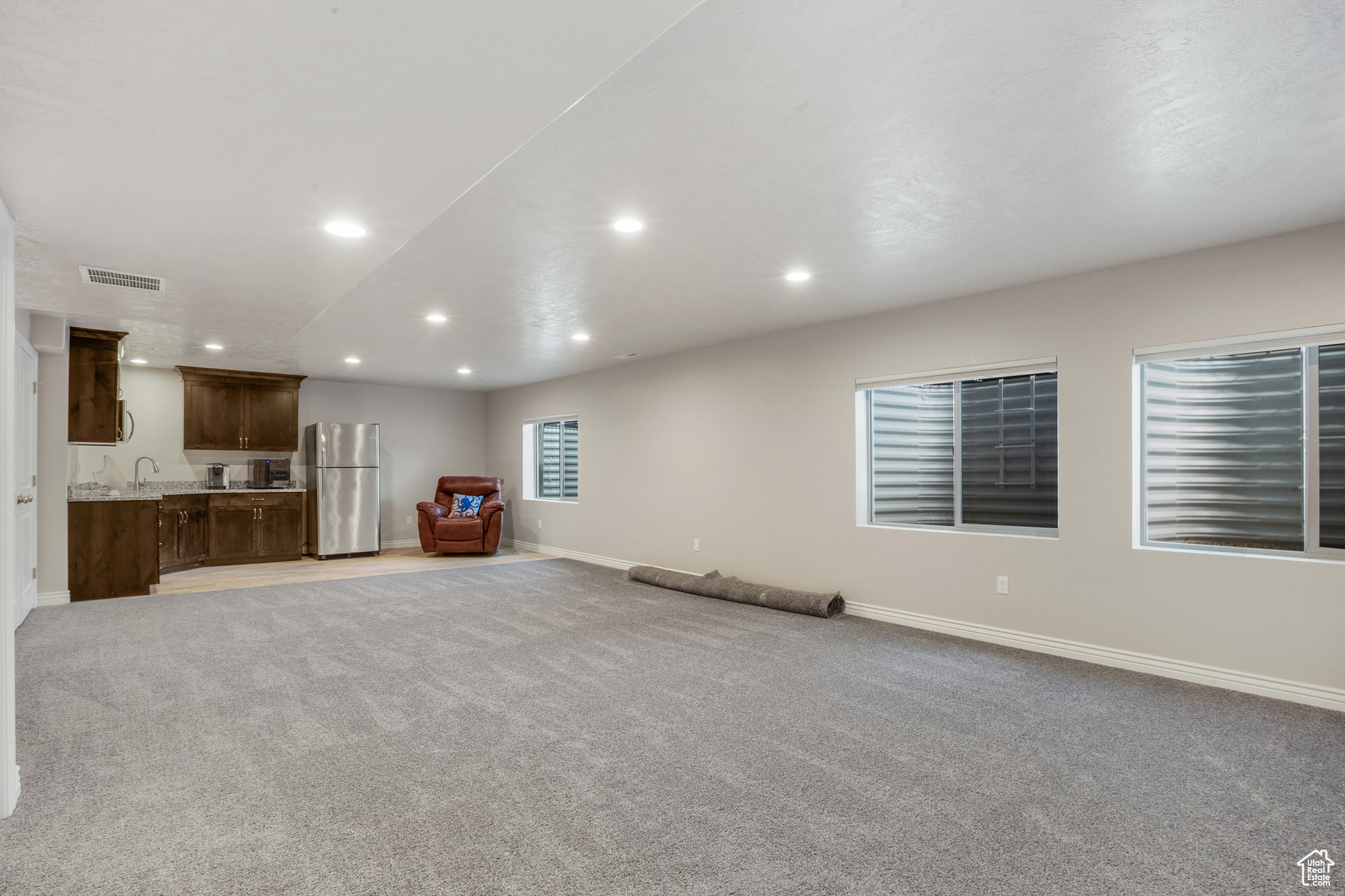 Unfurnished living room with light carpet