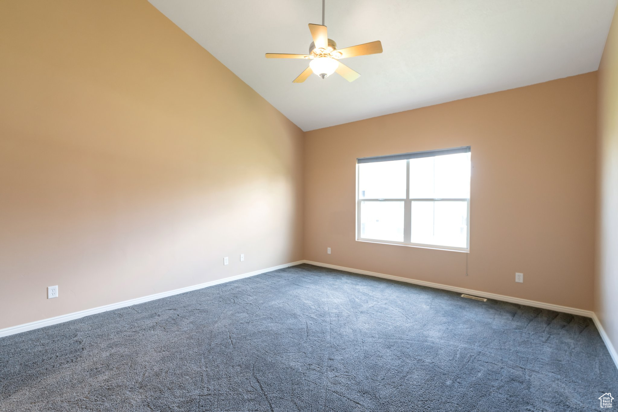Primary Bedroom featuring high vaulted ceiling, ceiling fan, and dark carpet