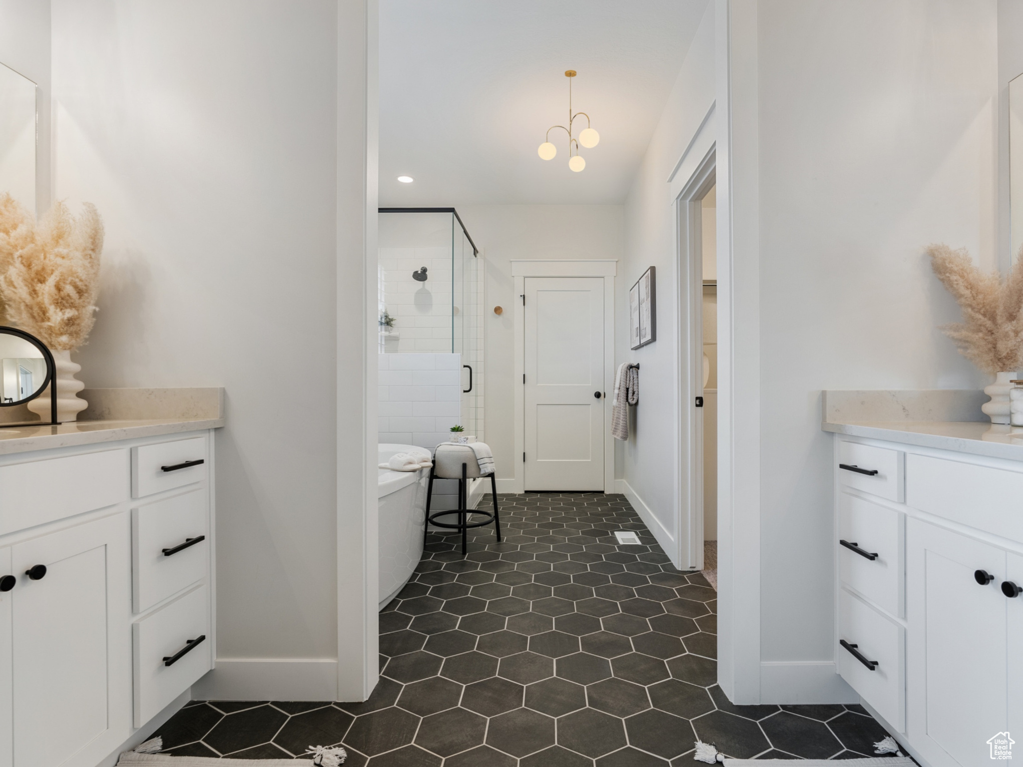 Expansive primary bathroom featuring separate vanities, oversized shower, freestanding tub and water closet.