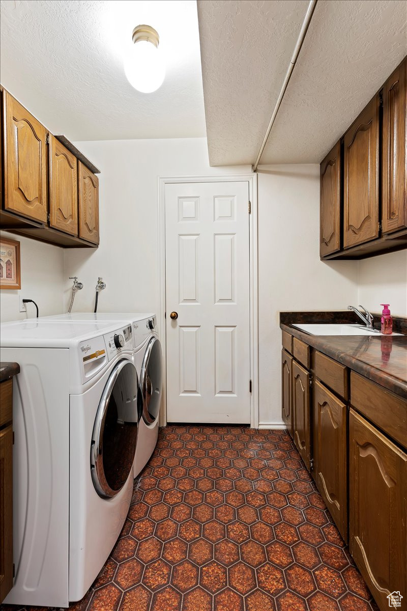 Laundry room with storage room and sink