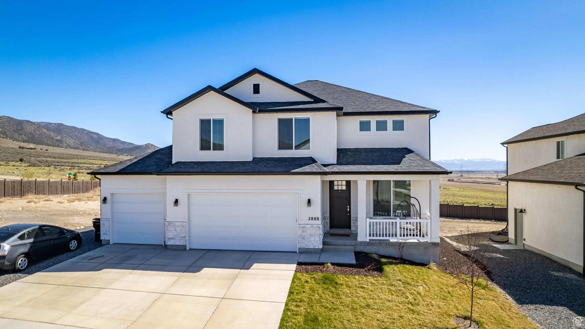 Front facade featuring a garage and a mountain view