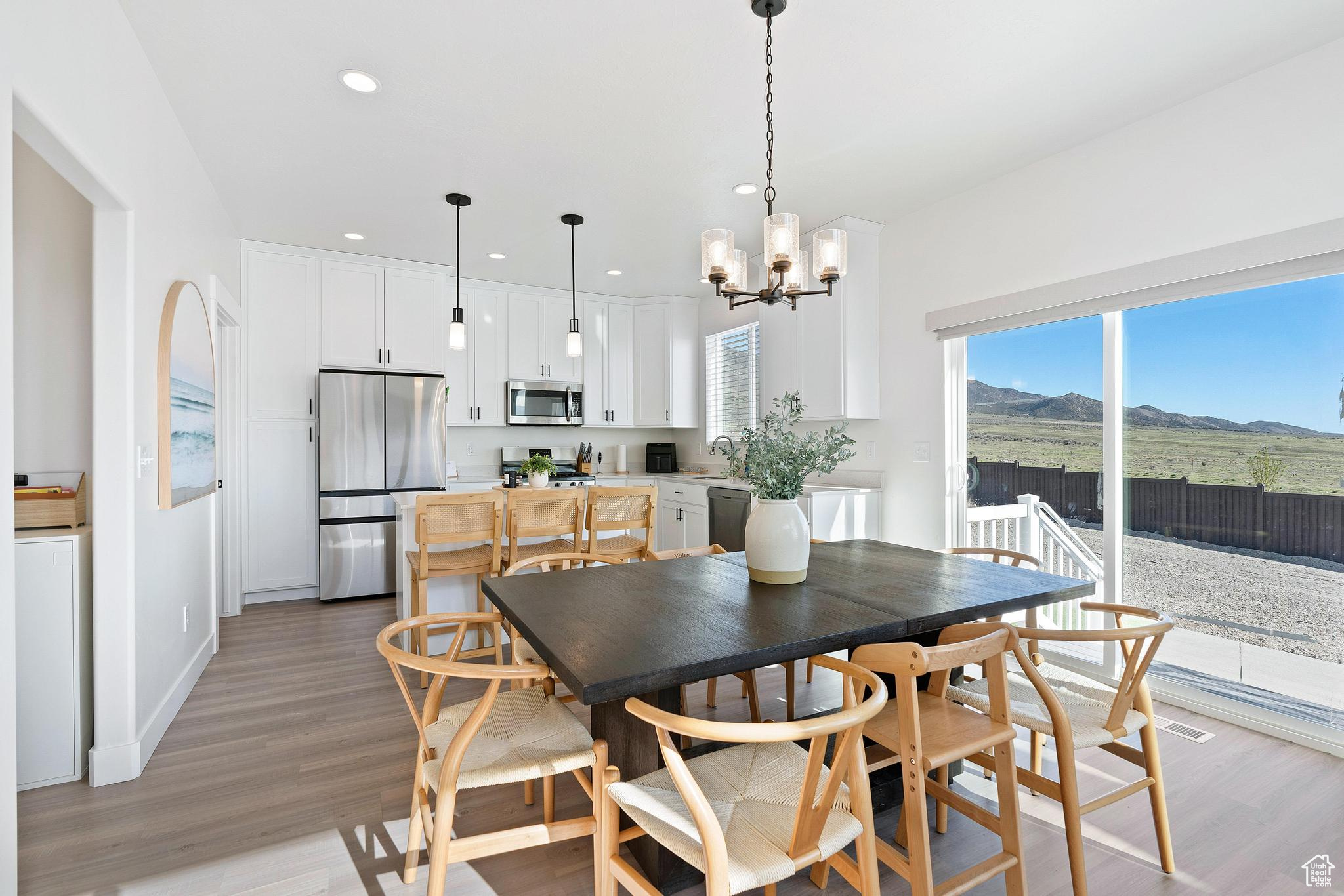 Dining area featuring a chandelier, light hardwood / wood-style flooring, and sink