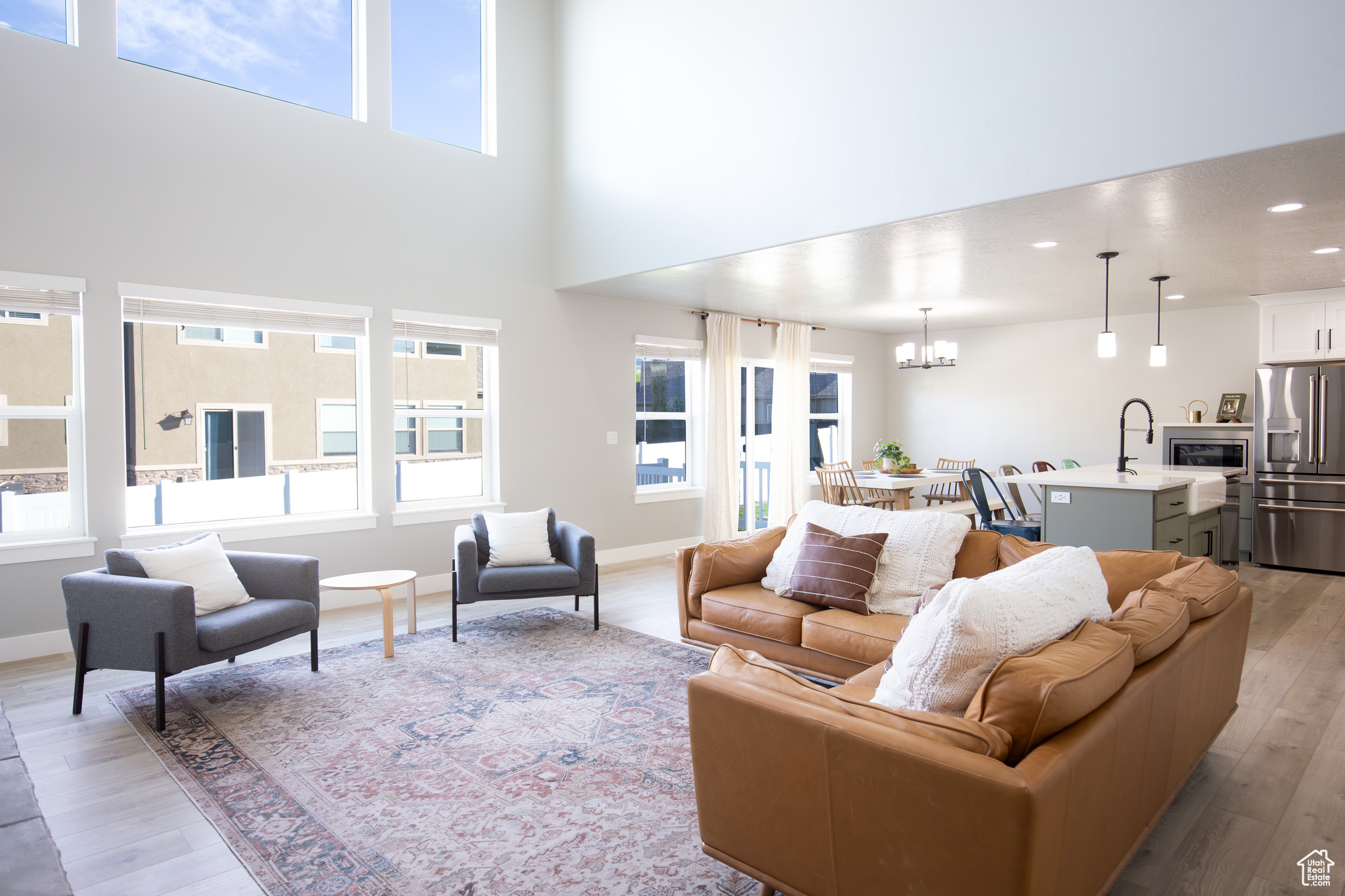 Living room with light hardwood / wood-style flooring and a chandelier