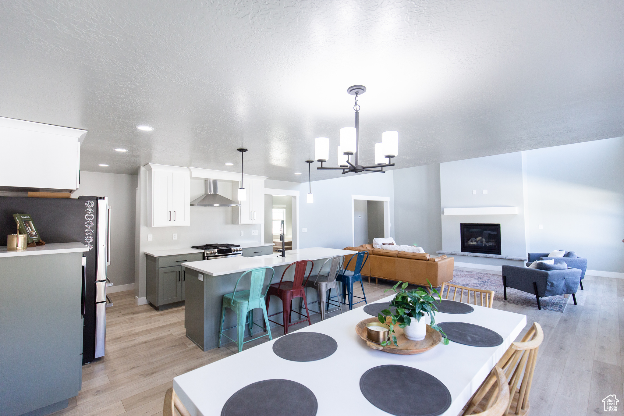 Dining space featuring an inviting chandelier, light hardwood / wood-style floors, and a textured ceiling