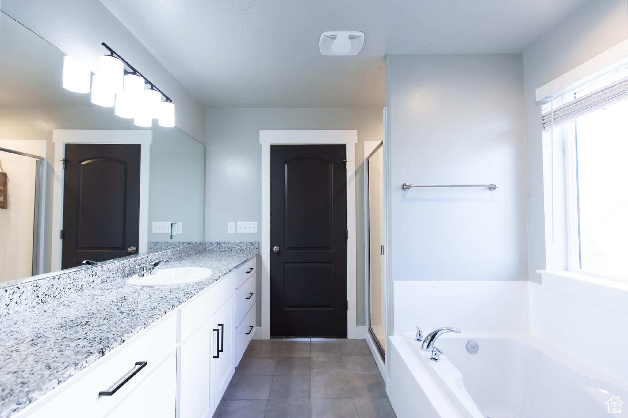 Bathroom with vanity, tile floors, and separate shower and tub