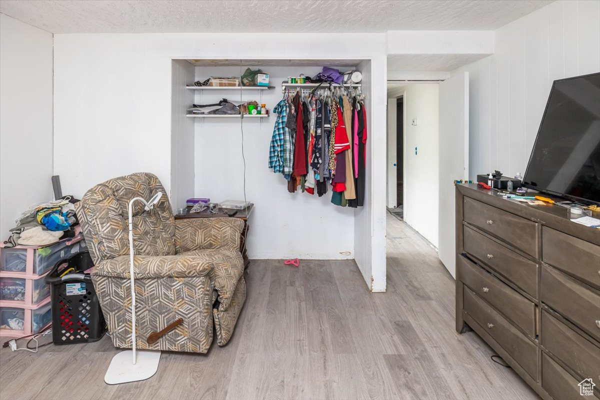 Interior space featuring light hardwood / wood-style flooring, a closet, and a textured ceiling