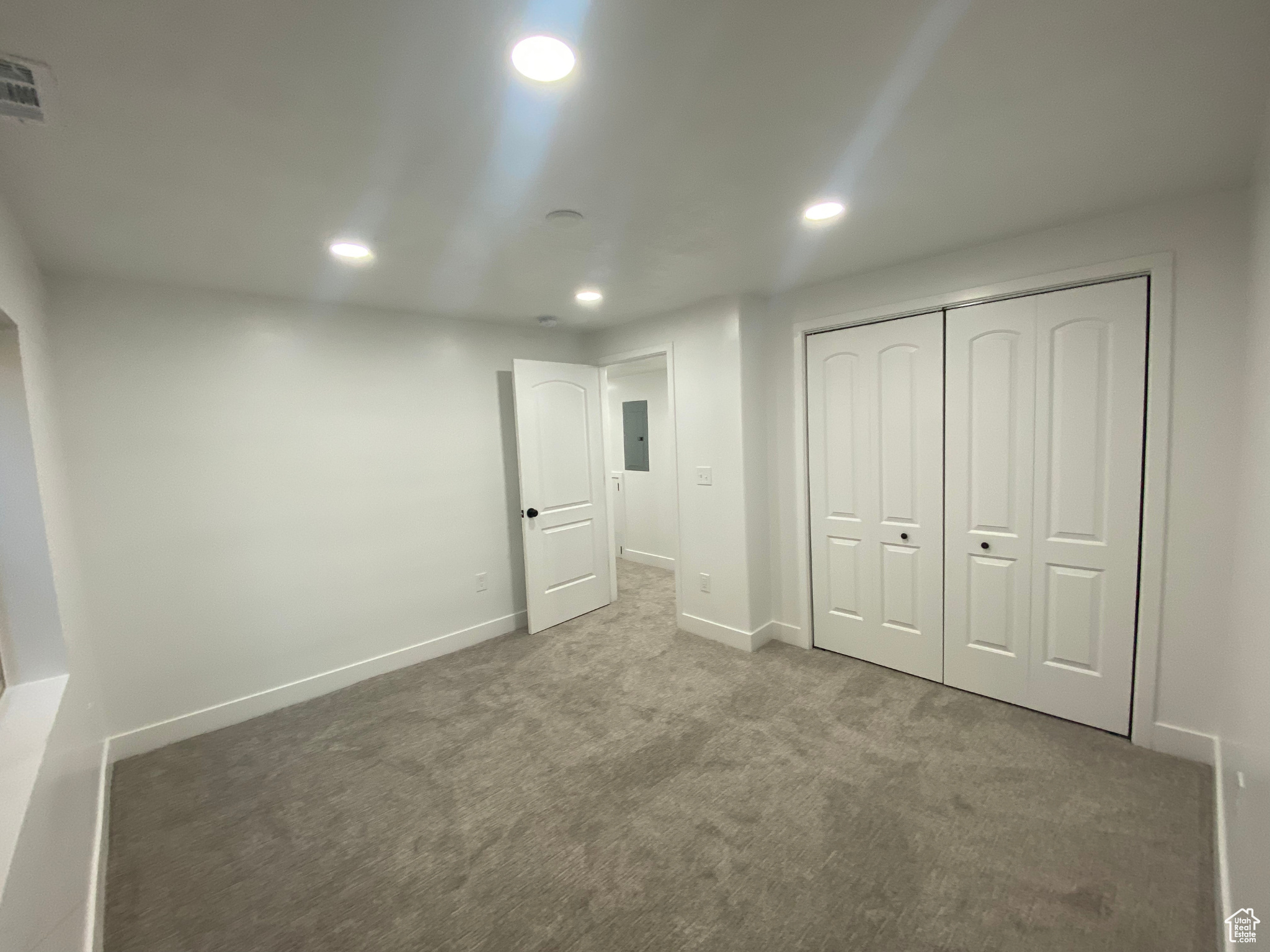 Unfurnished bedroom with a closet and carpet floors