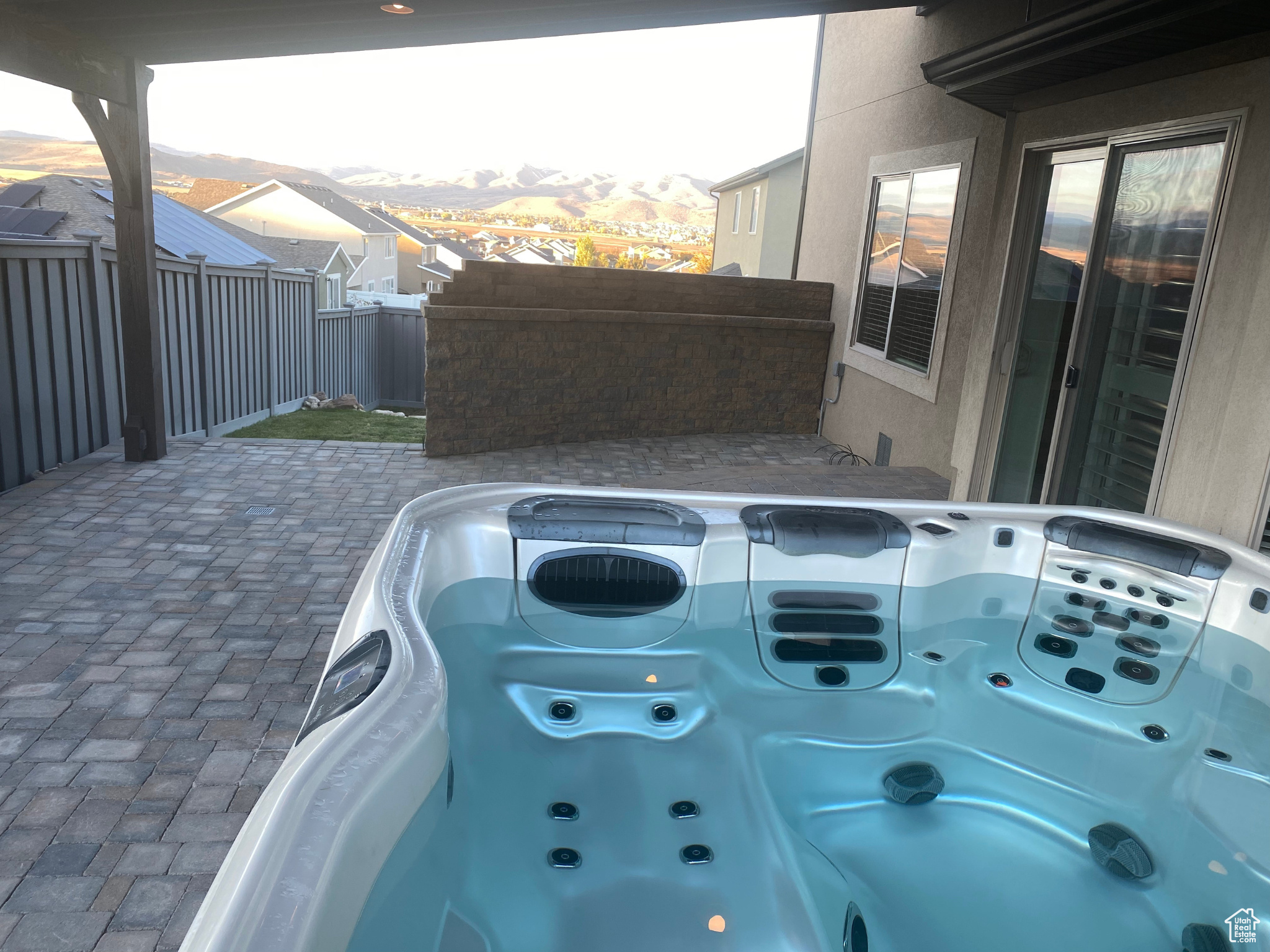 View of working hot tub on stone patio
