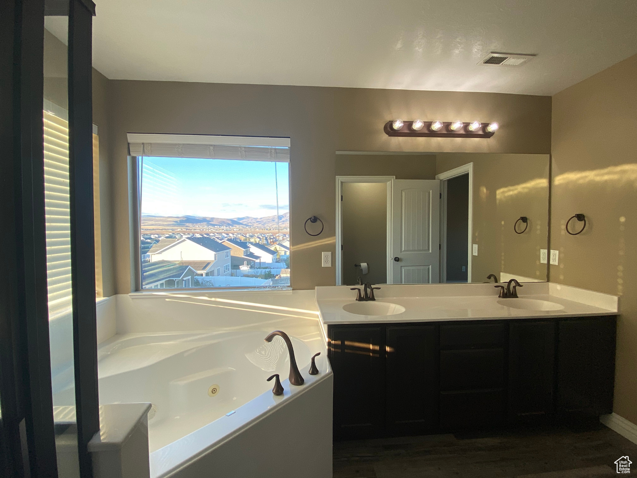 Master Bathroom featuring double vanity, separate shower and  jetted tub with valley views