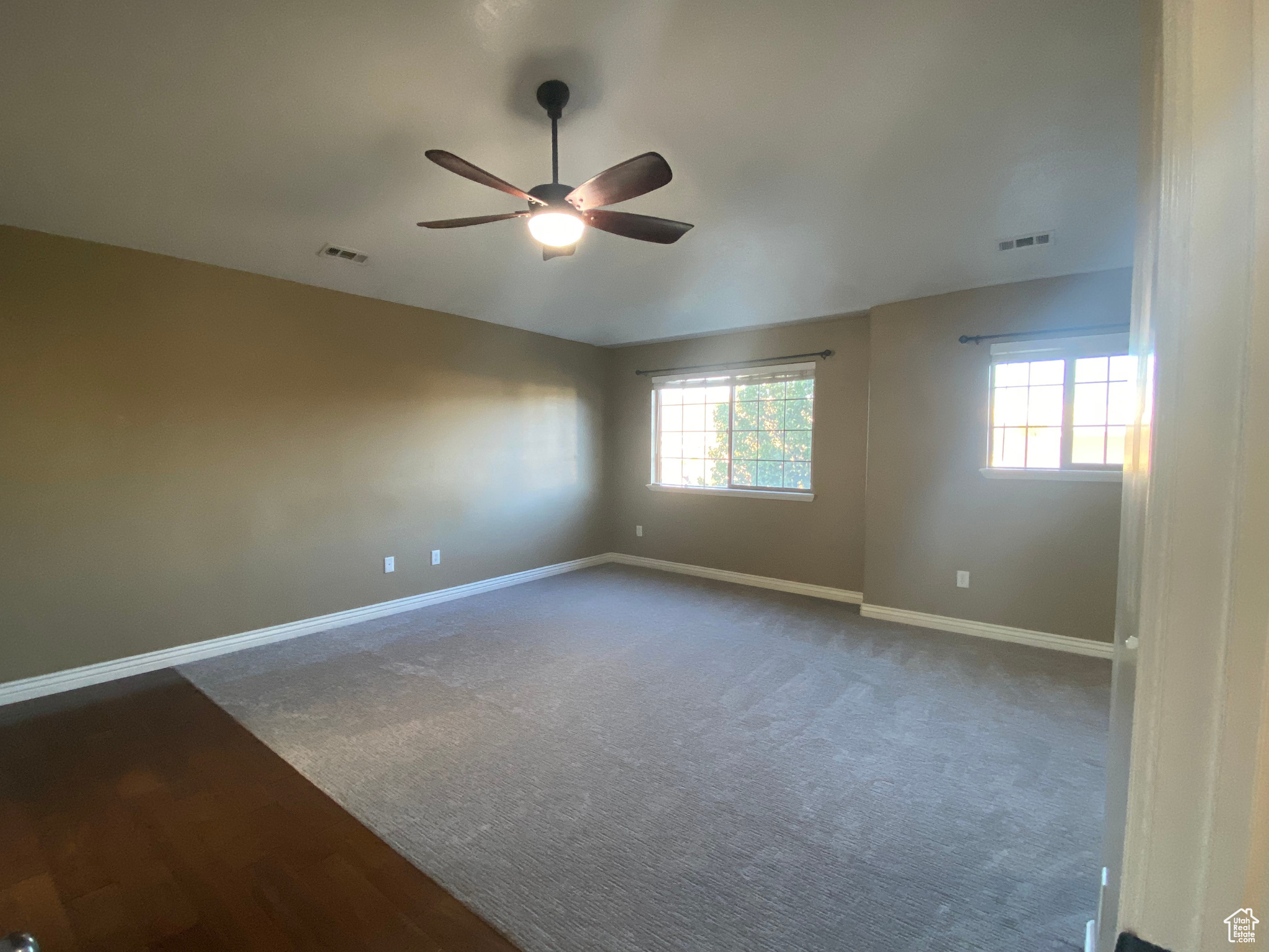 Master bedroom suite with ceiling fan and carpet