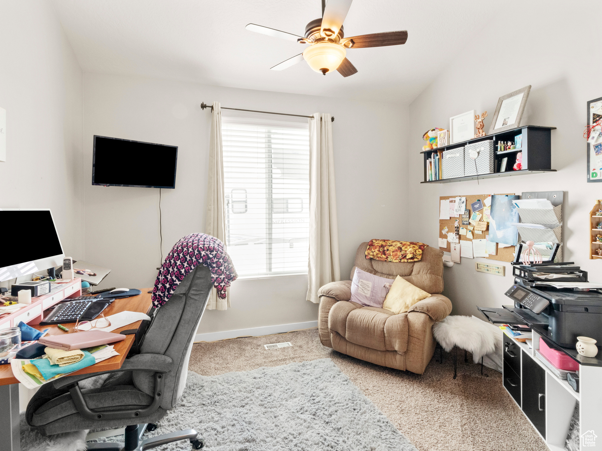 Home office featuring ceiling fan, a healthy amount of sunlight, and carpet floors