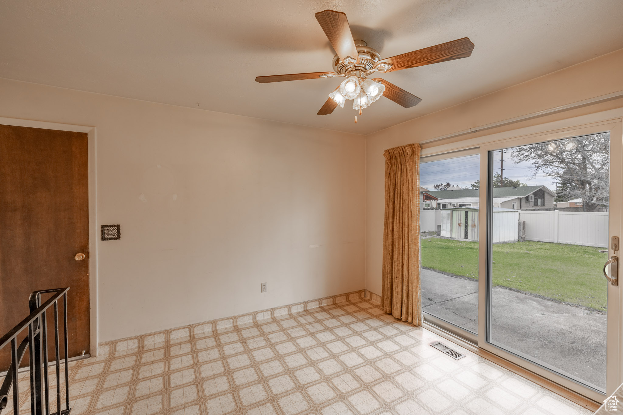 Tiled empty room featuring ceiling fan