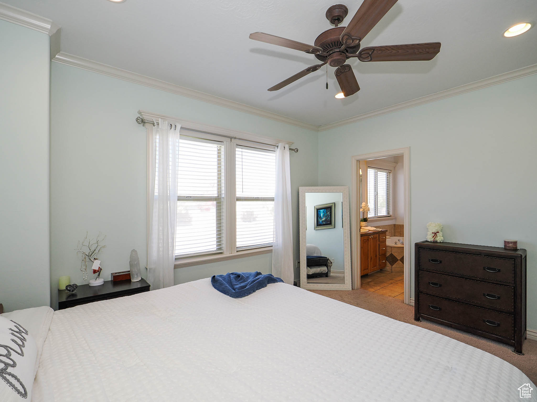 Master bedroom featuring crown molding, ceiling fan, and ensuite bathroom