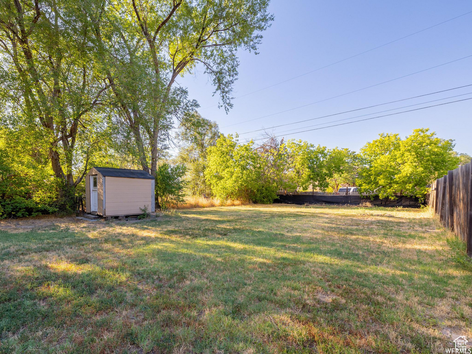 Fully fenced, large yard with storage shed