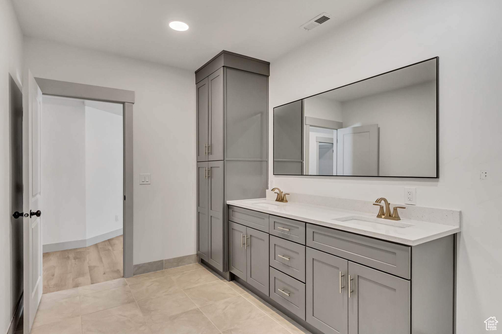 Bathroom with hardwood / wood-style floors, oversized vanity, and dual sinks