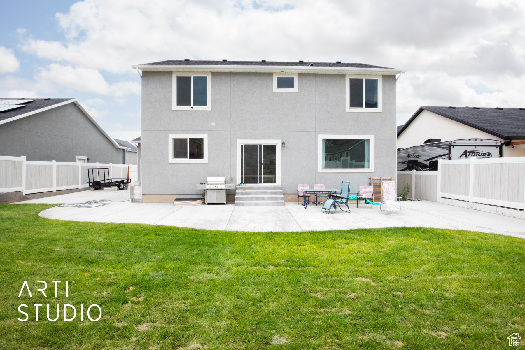 Rear view of property featuring a patio and a yard