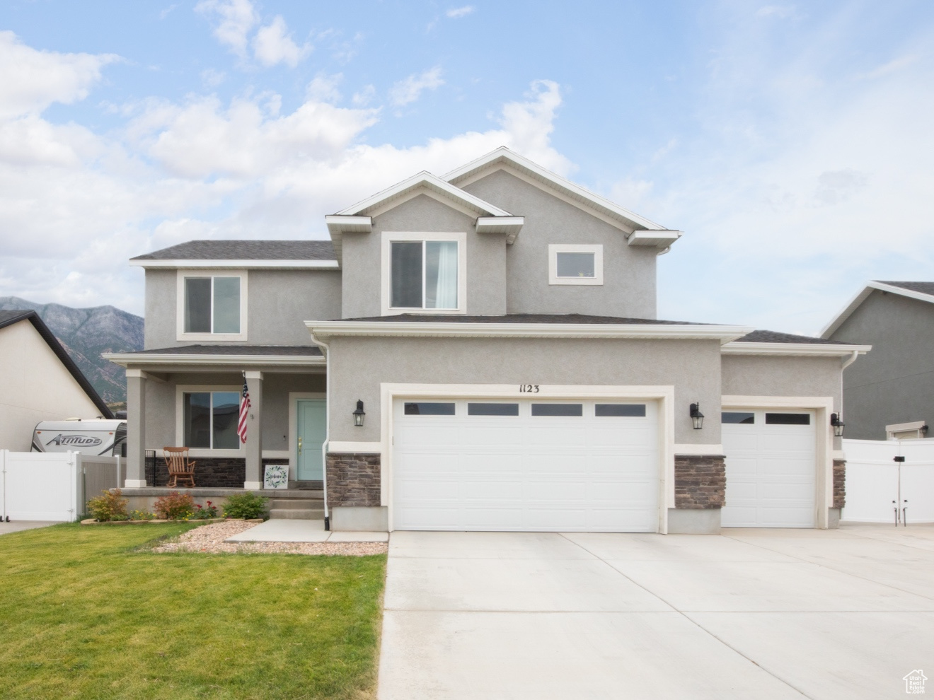 View of front of house featuring a garage and a front lawn