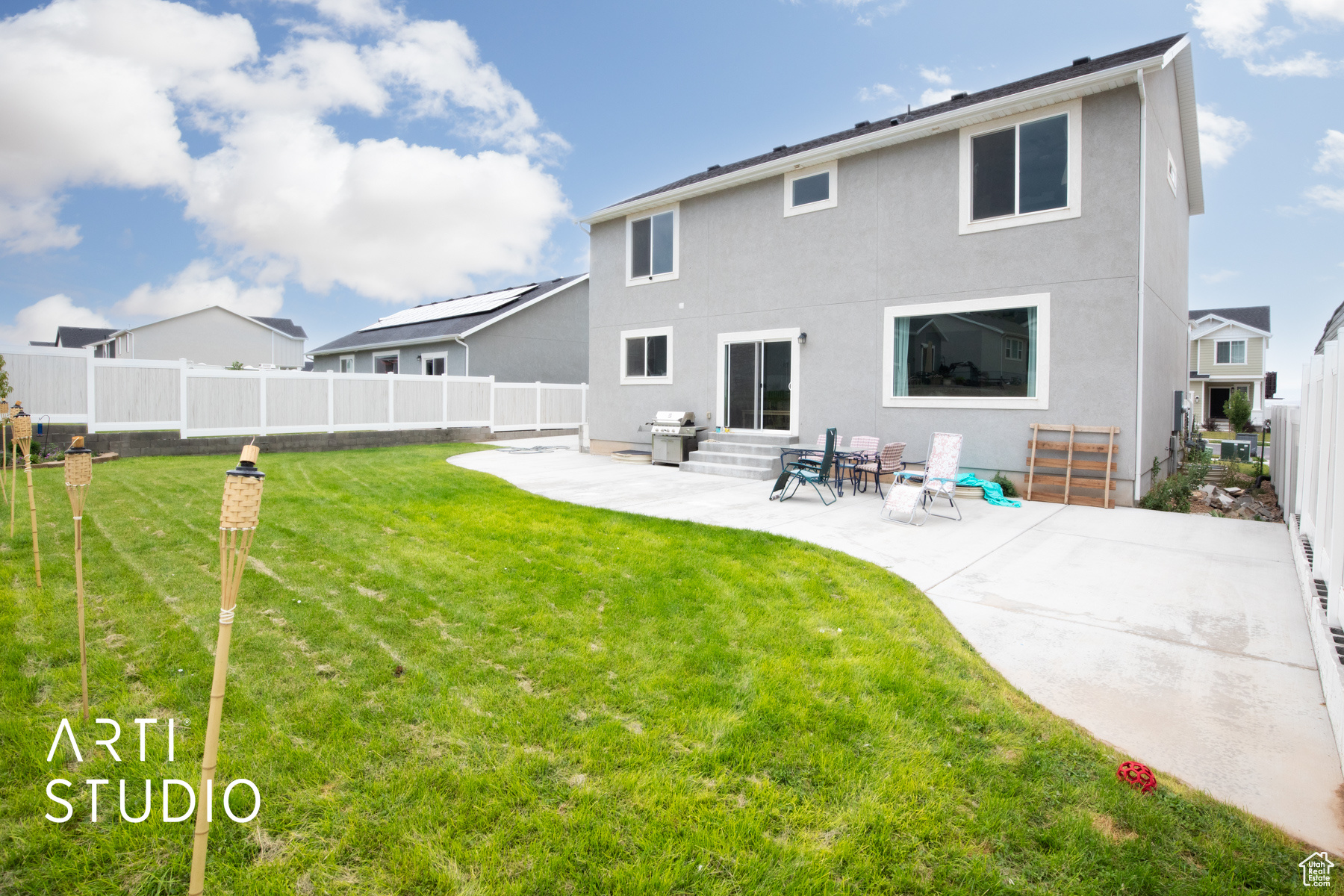 Rear view of house featuring a lawn and a patio area