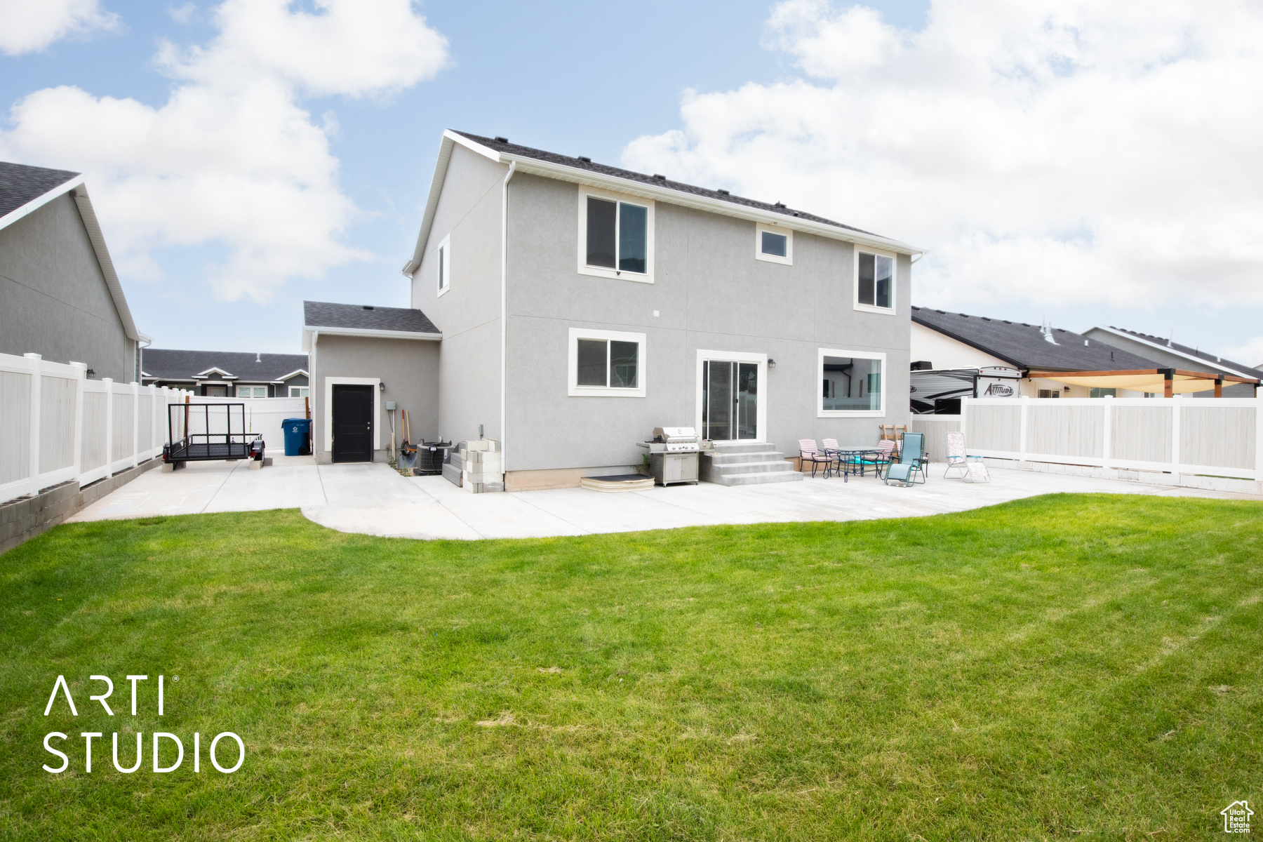 Rear view of property featuring a patio and a lawn