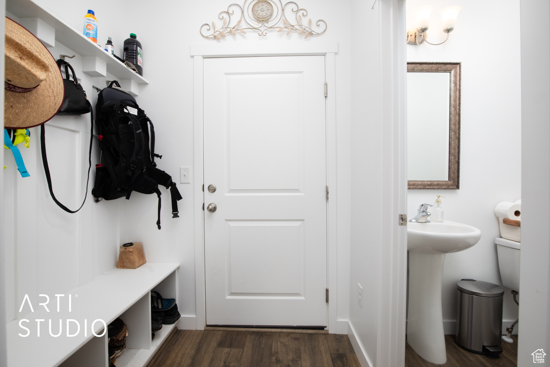 Mudroom with dark hardwood / wood-style floors and sink