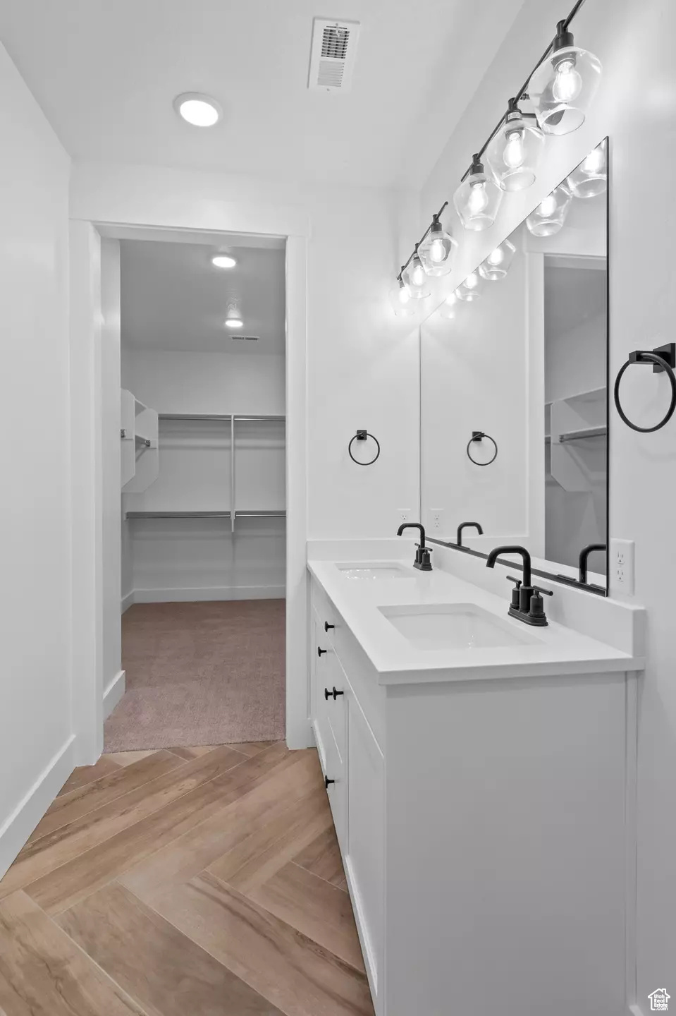 Bathroom featuring oversized vanity and parquet floors