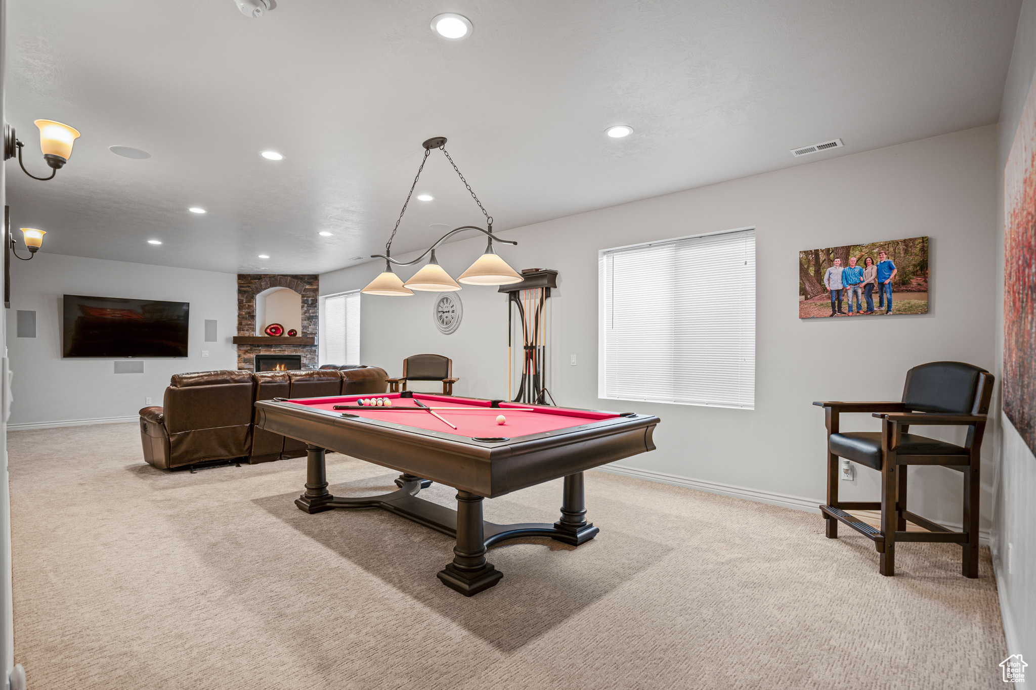 Playroom featuring light carpet, brick wall, a fireplace, and pool table