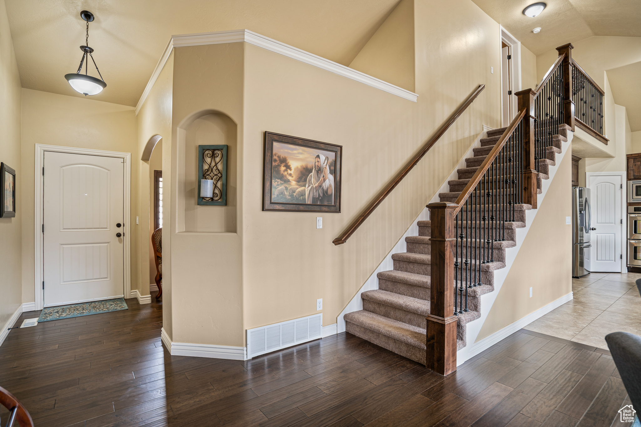 Foyer with a towering ceiling and tile floors