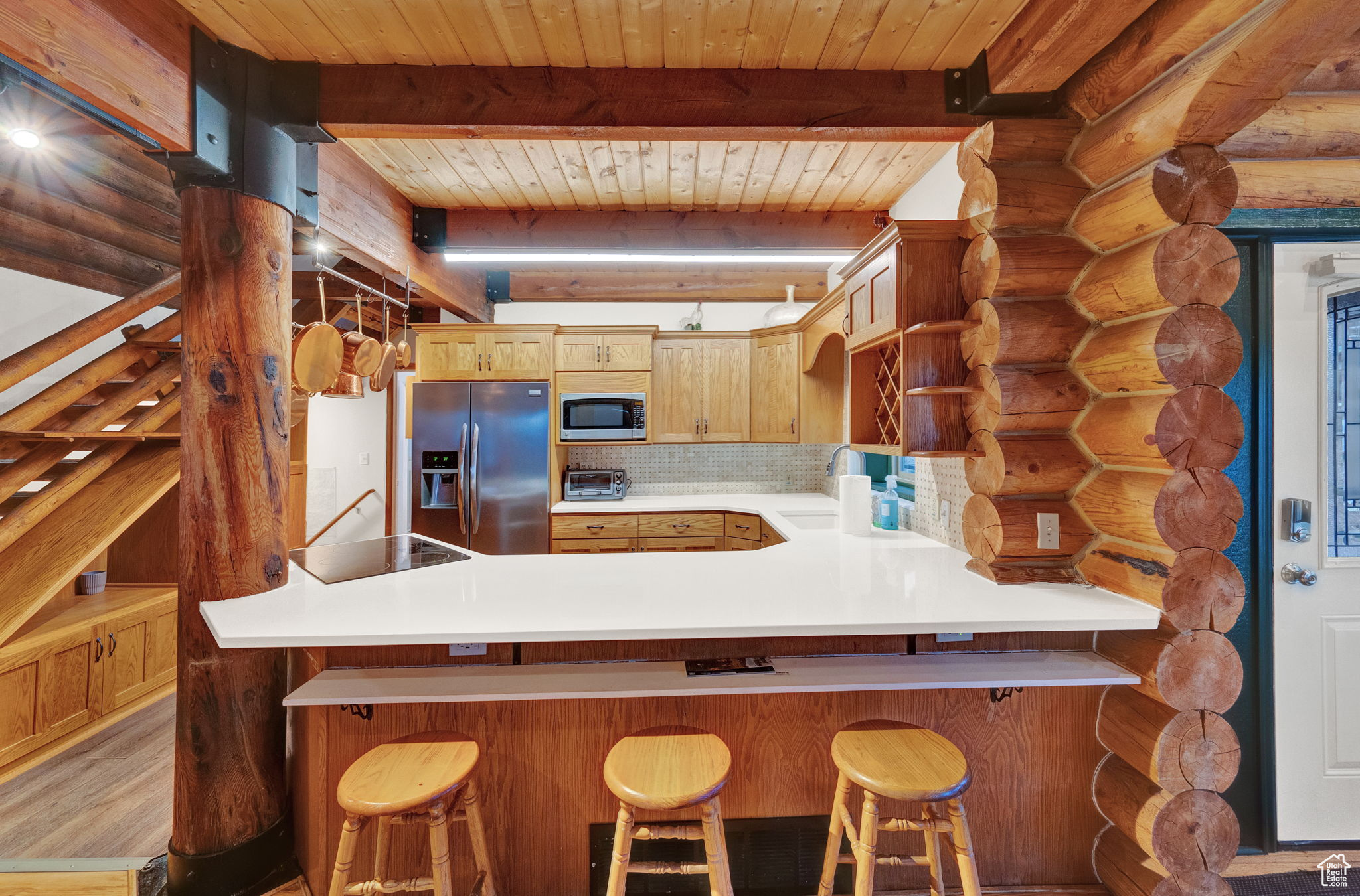 Kitchen featuring wooden ceiling, beam ceiling, and stainless steel appliances