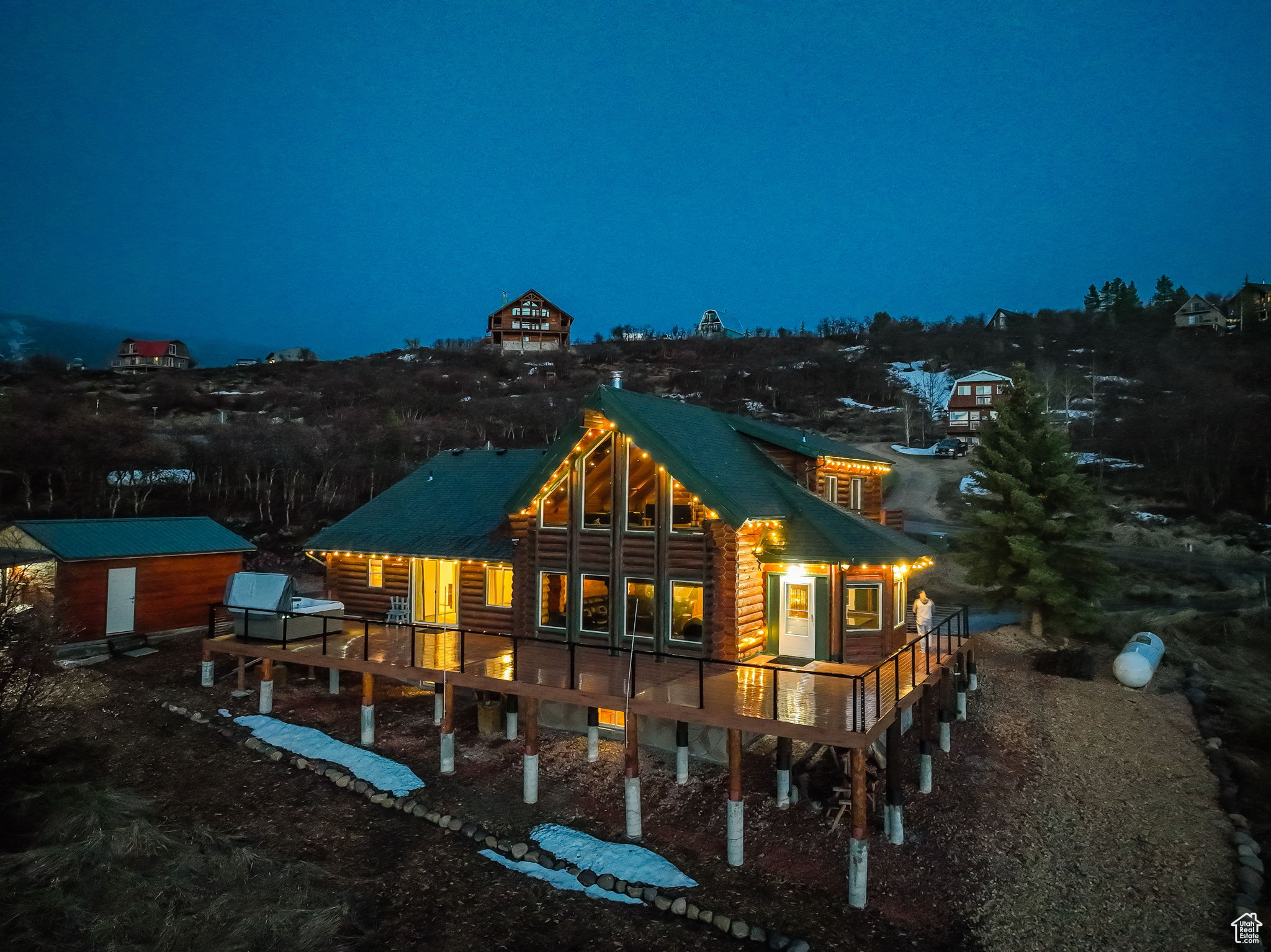 Back house at twilight with an outdoor structure