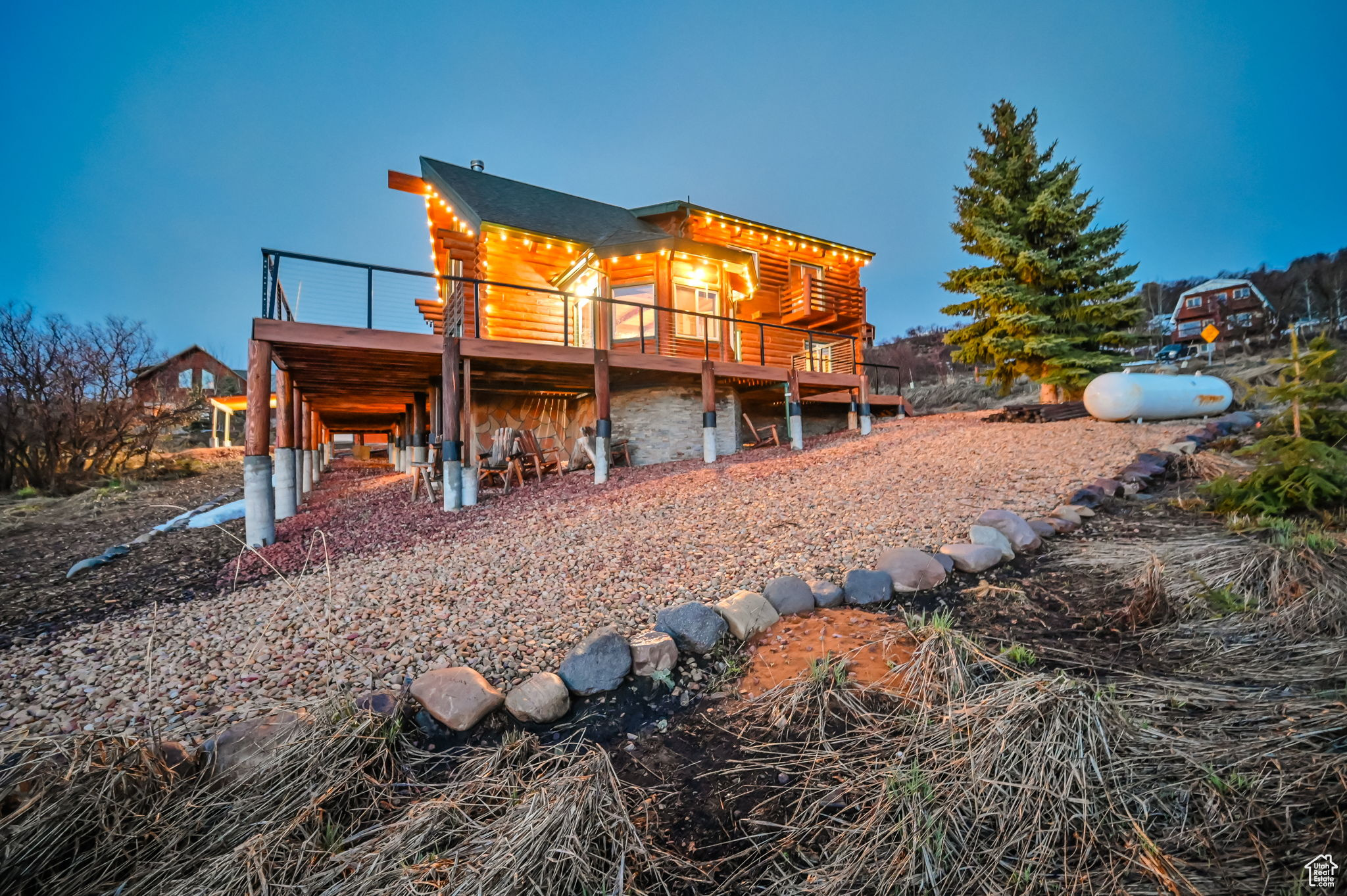 Back of property with a wooden deck and a balcony