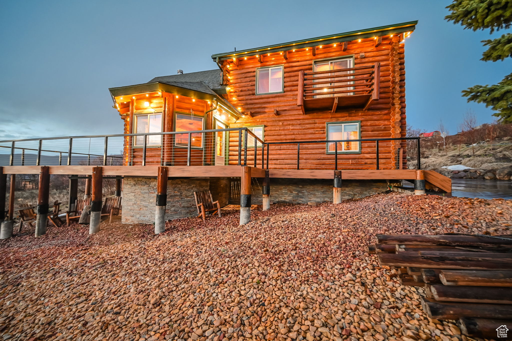 Back house at dusk featuring a wooden deck