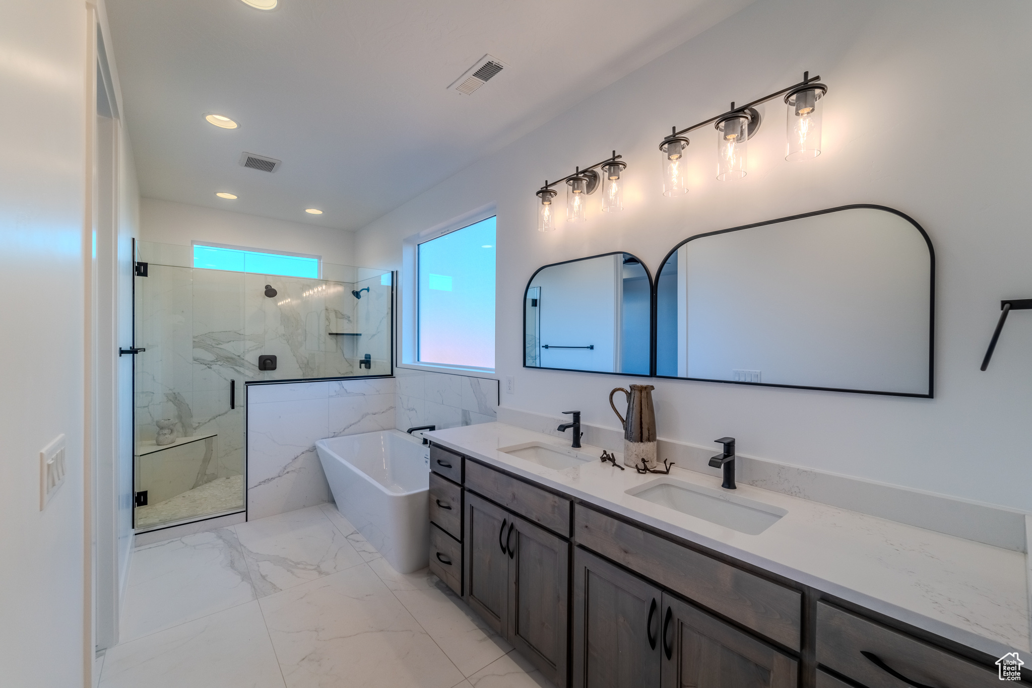 Bathroom featuring tile patterned floors, separate shower and tub, and vanity