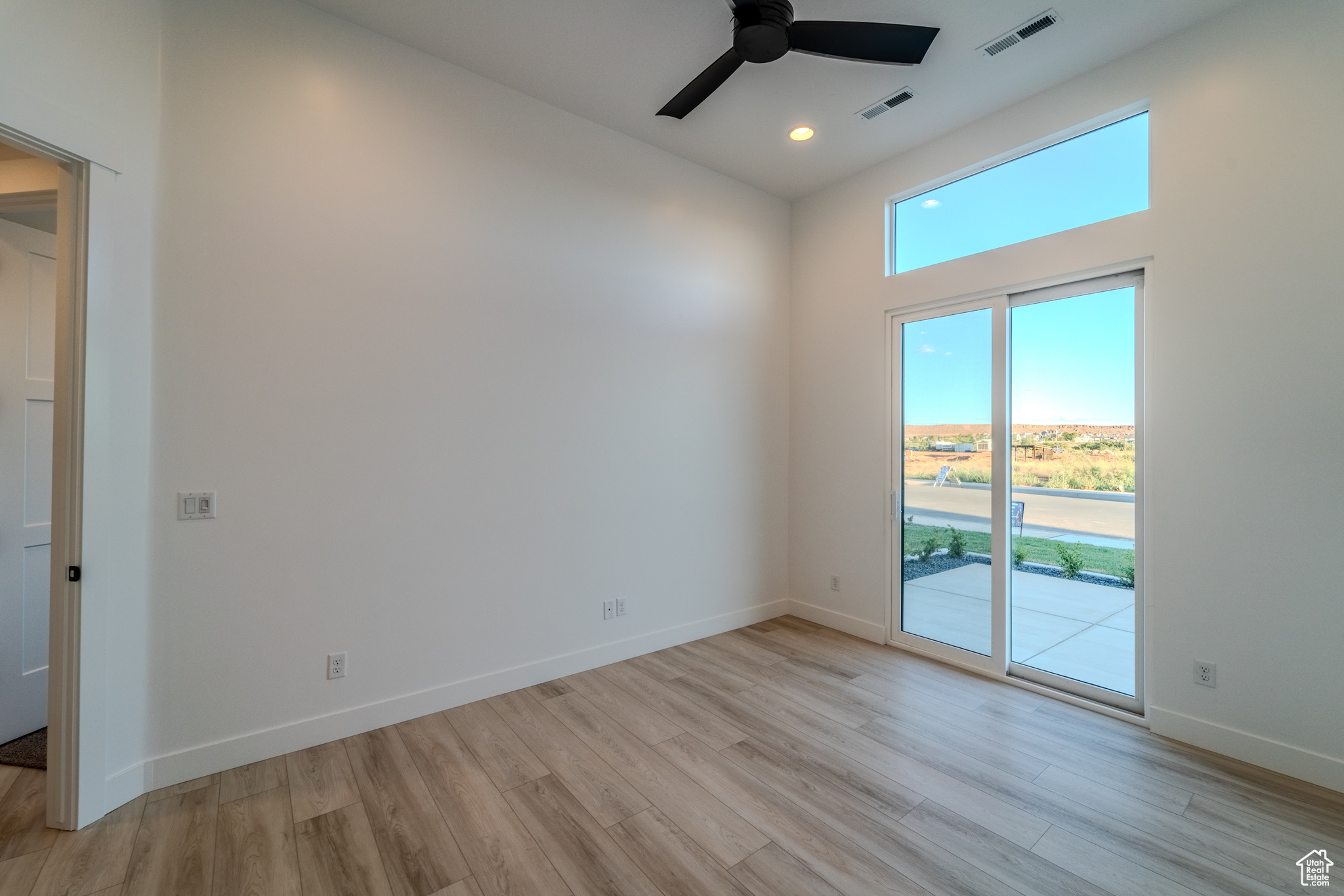 Spare room featuring ceiling fan and light hardwood / wood-style floors