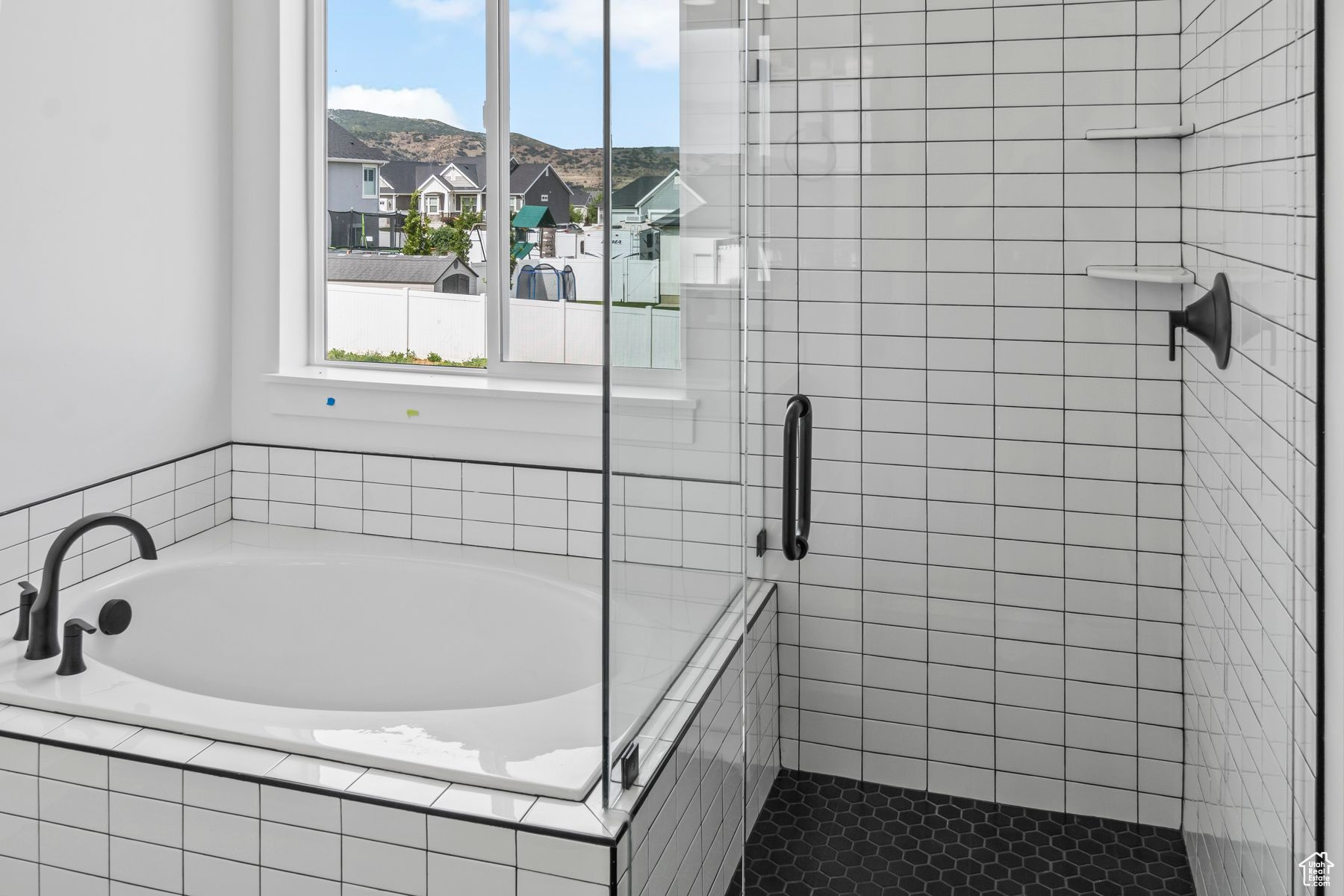 Bathroom featuring a relaxing tiled bath and tile floors