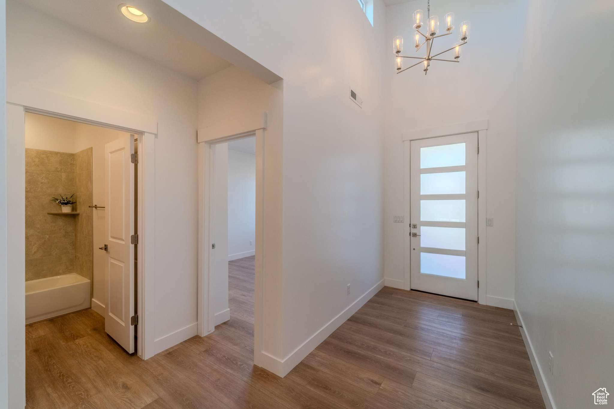 Foyer featuring hardwood / wood-style flooring and an inviting chandelier