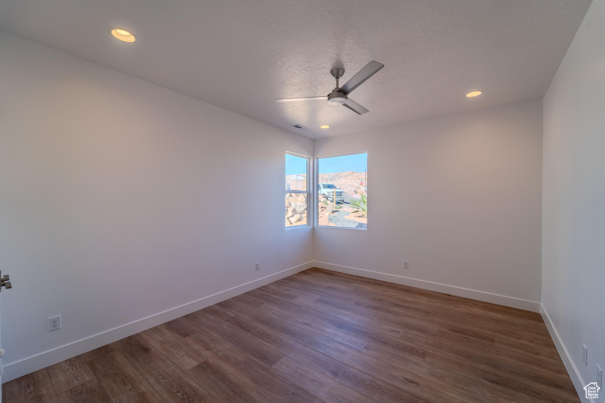 Unfurnished room featuring ceiling fan and wood-type flooring