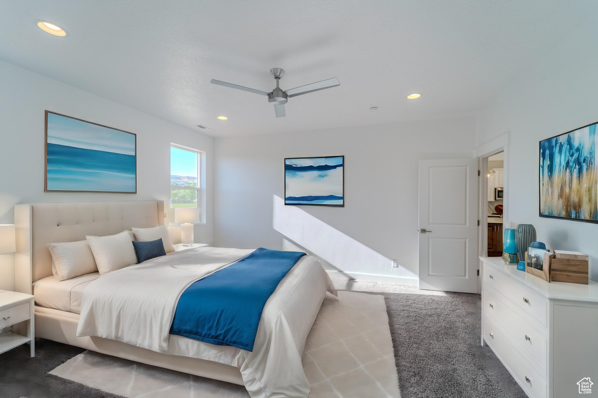 Carpeted bedroom with ceiling fan