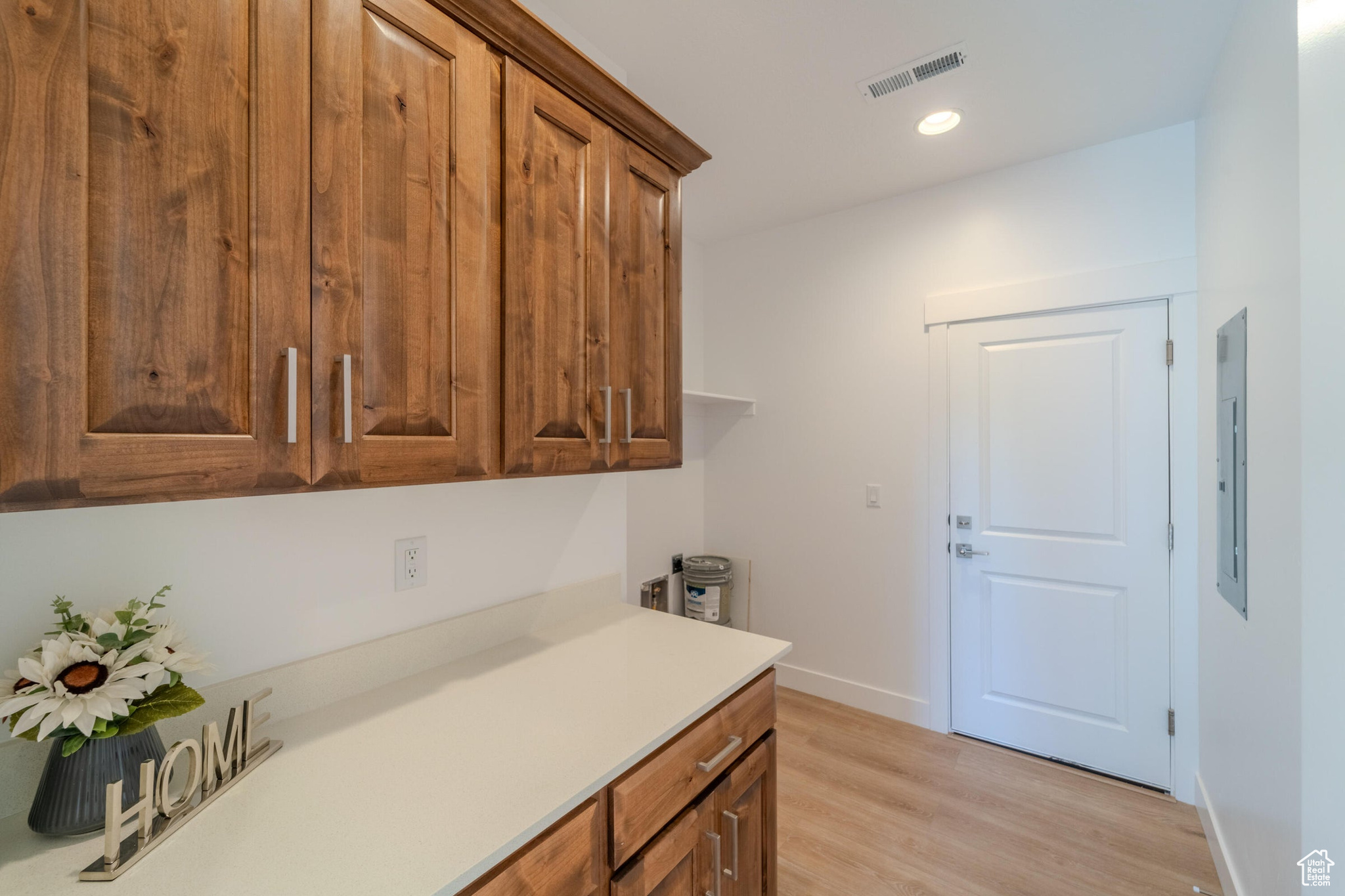 Kitchen with light hardwood / wood-style floors and electric panel