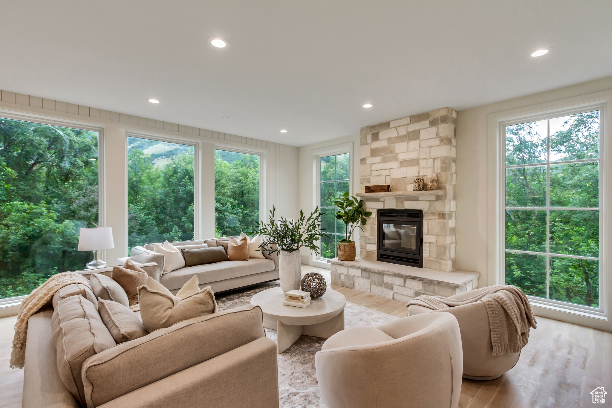 Living room with a healthy amount of sunlight, a fireplace, and light wood-type flooring