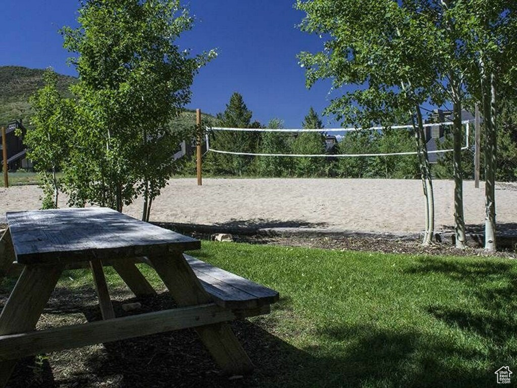 Surrounding community featuring volleyball court and a yard