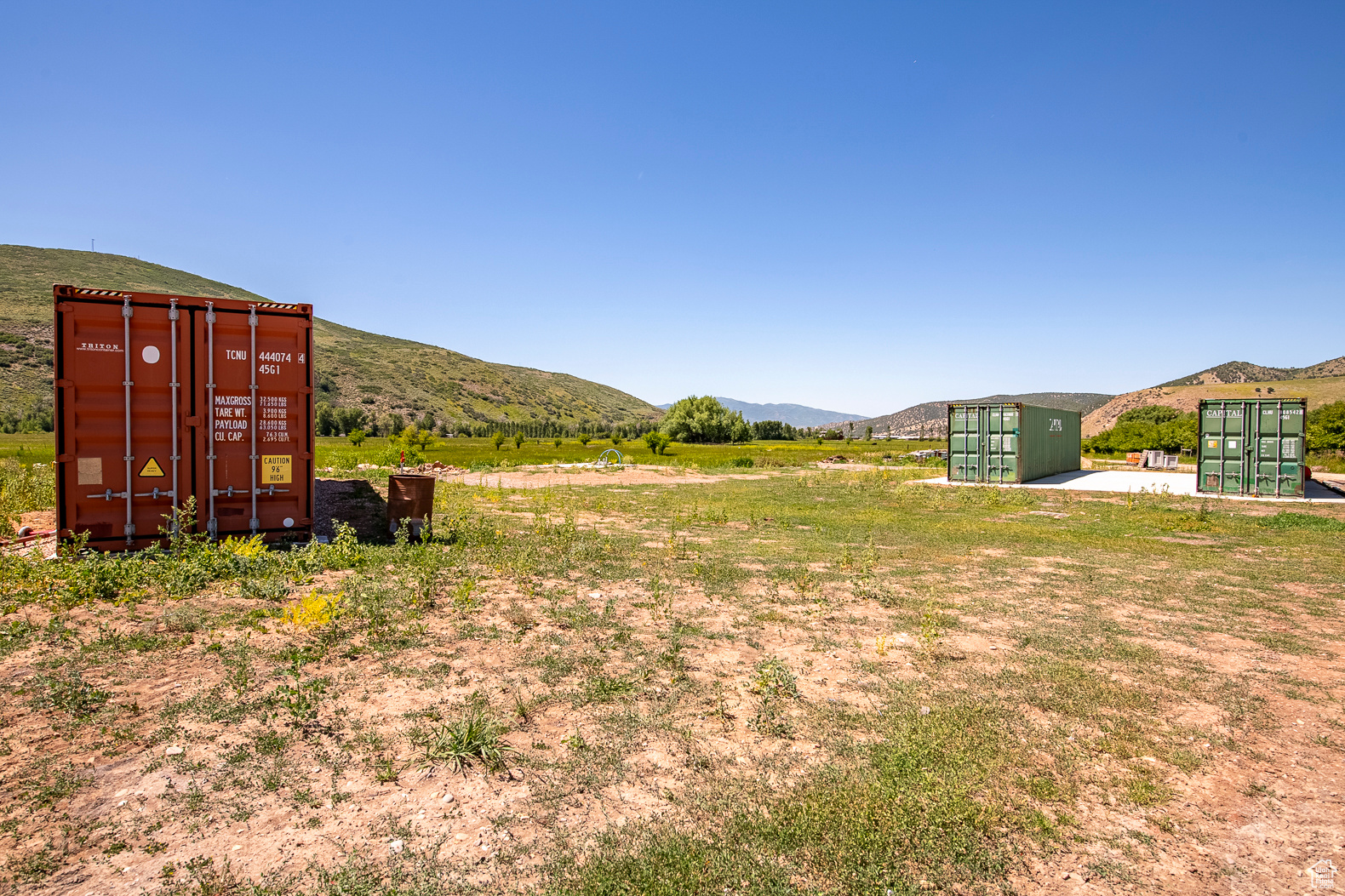 View of yard with a mountain view and a storage unit