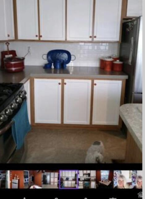 Kitchen with white cabinets and backsplash