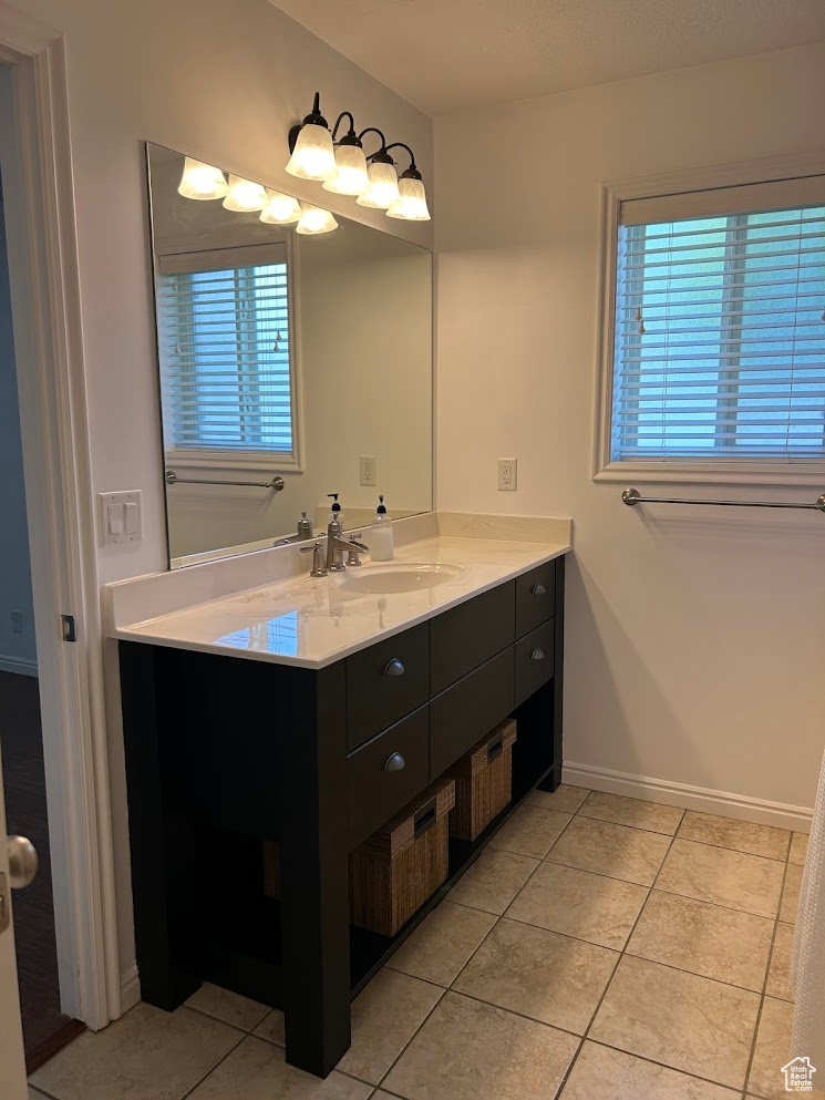 Master bathroom with vanity, tile patterned floors, and plenty of natural light