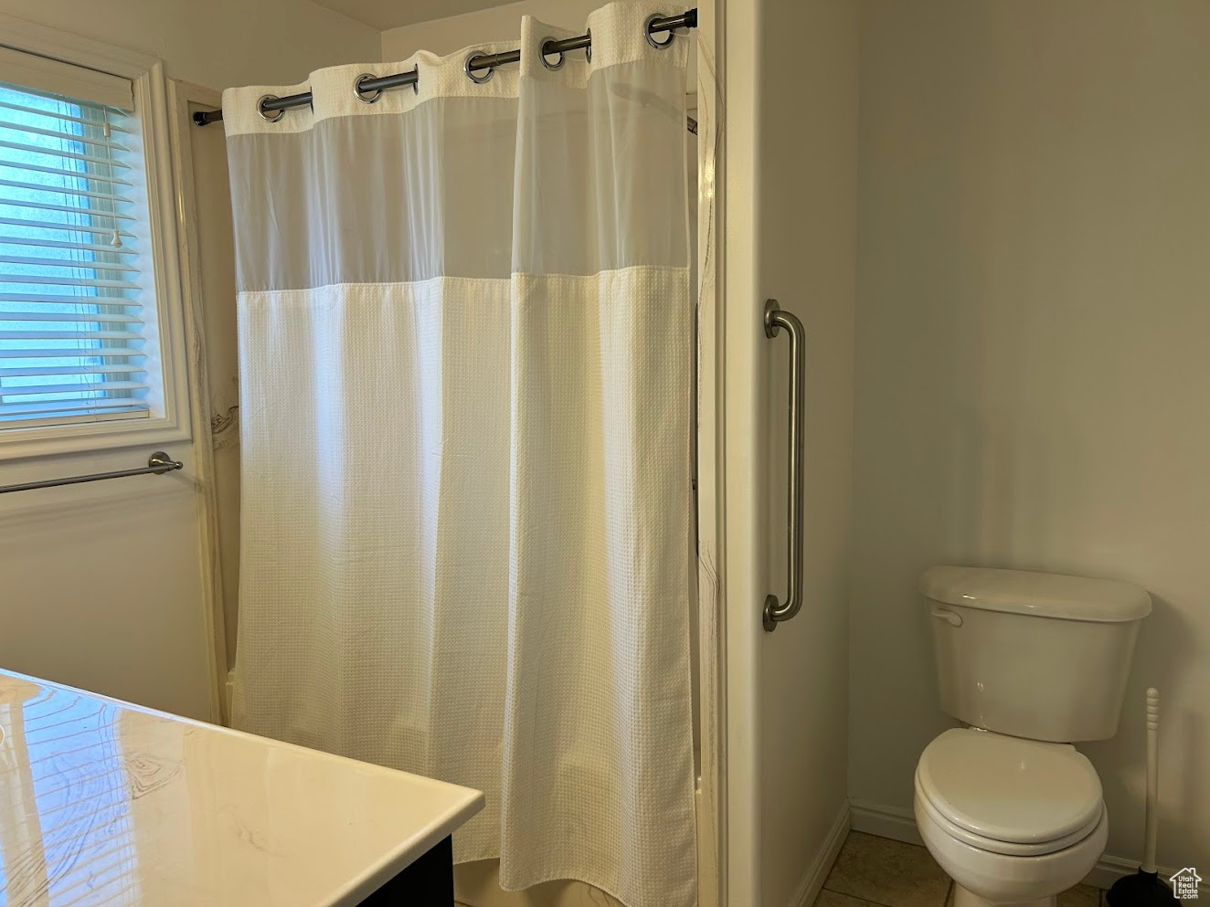 Bathroom with tile patterned floors, toilet, and vanity