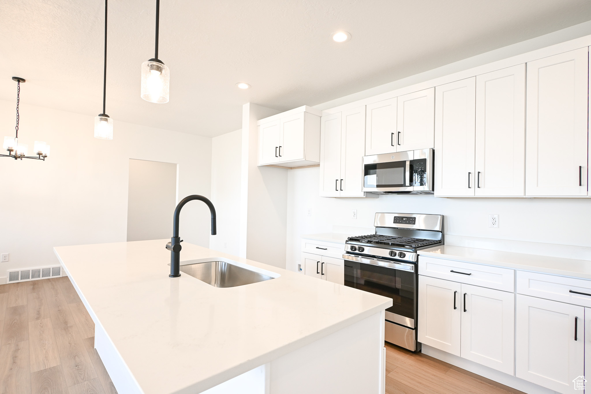 beautiful kitchen with soft close cabinets, quartz countertops, and upgraded plumbing and electrical fixtures, and appliances.