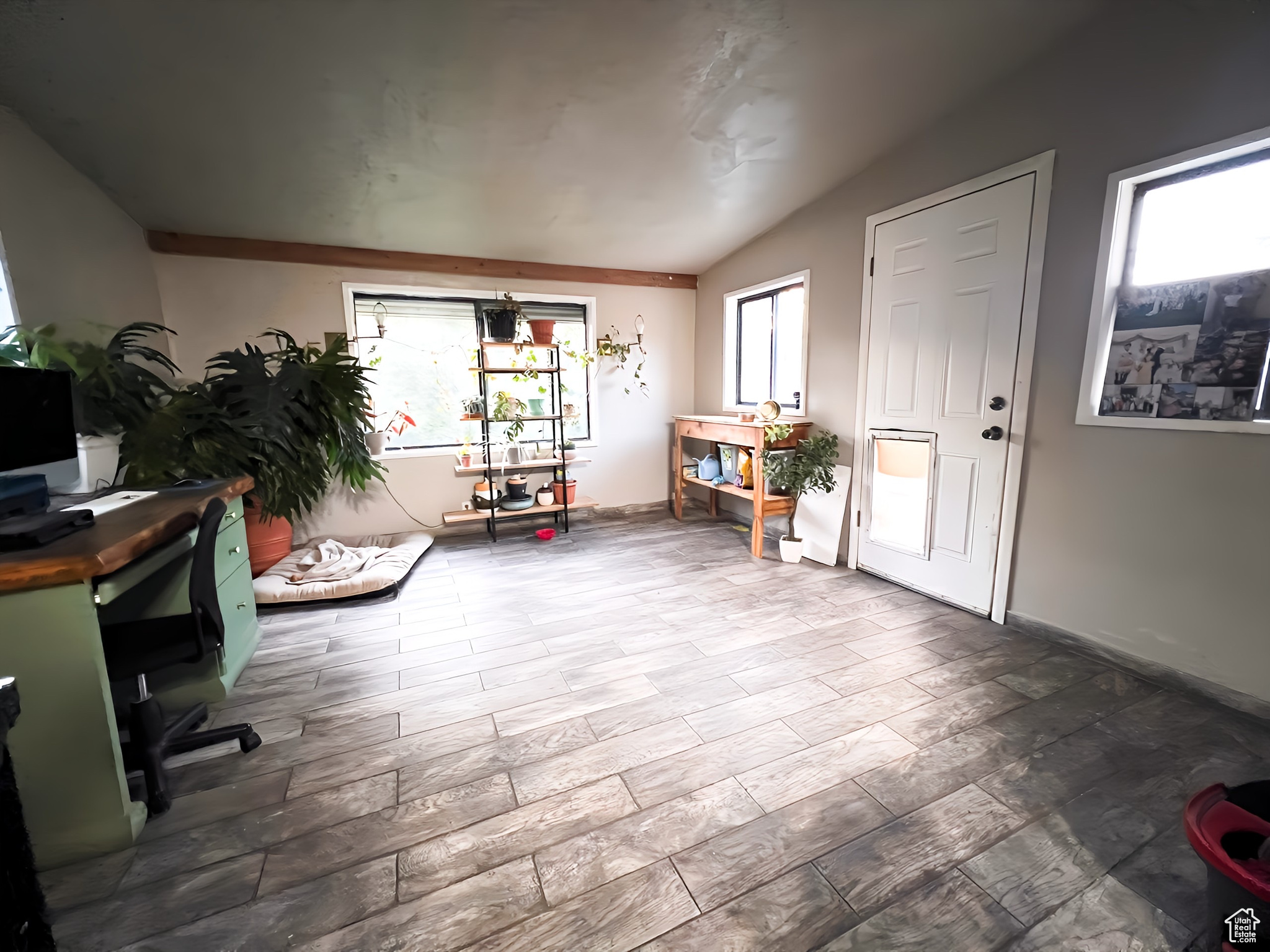 Interior space with lofted ceiling and hardwood / wood-style flooring