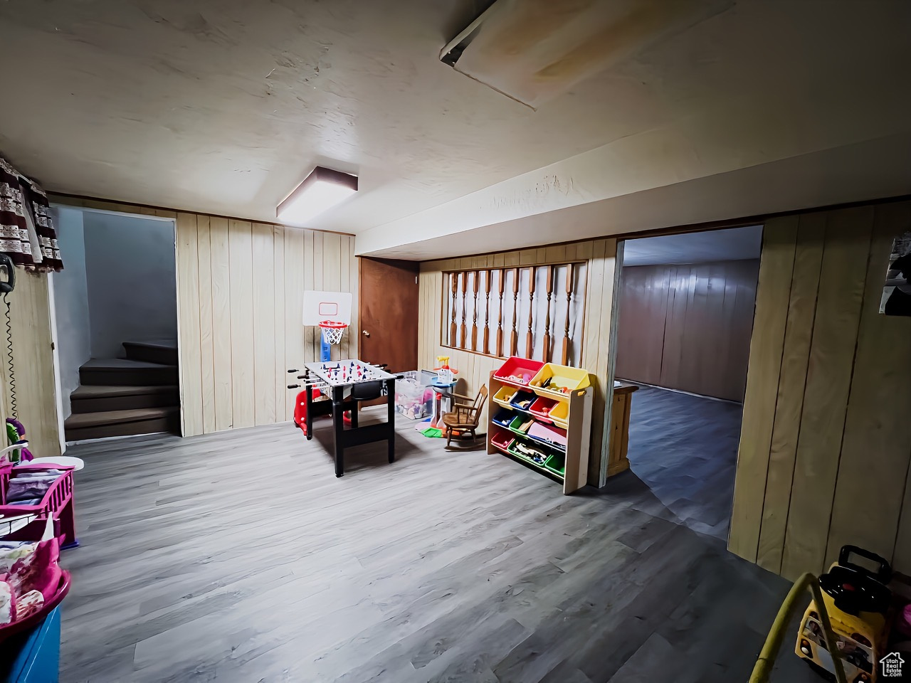 Basement with wood walls and wood-type flooring