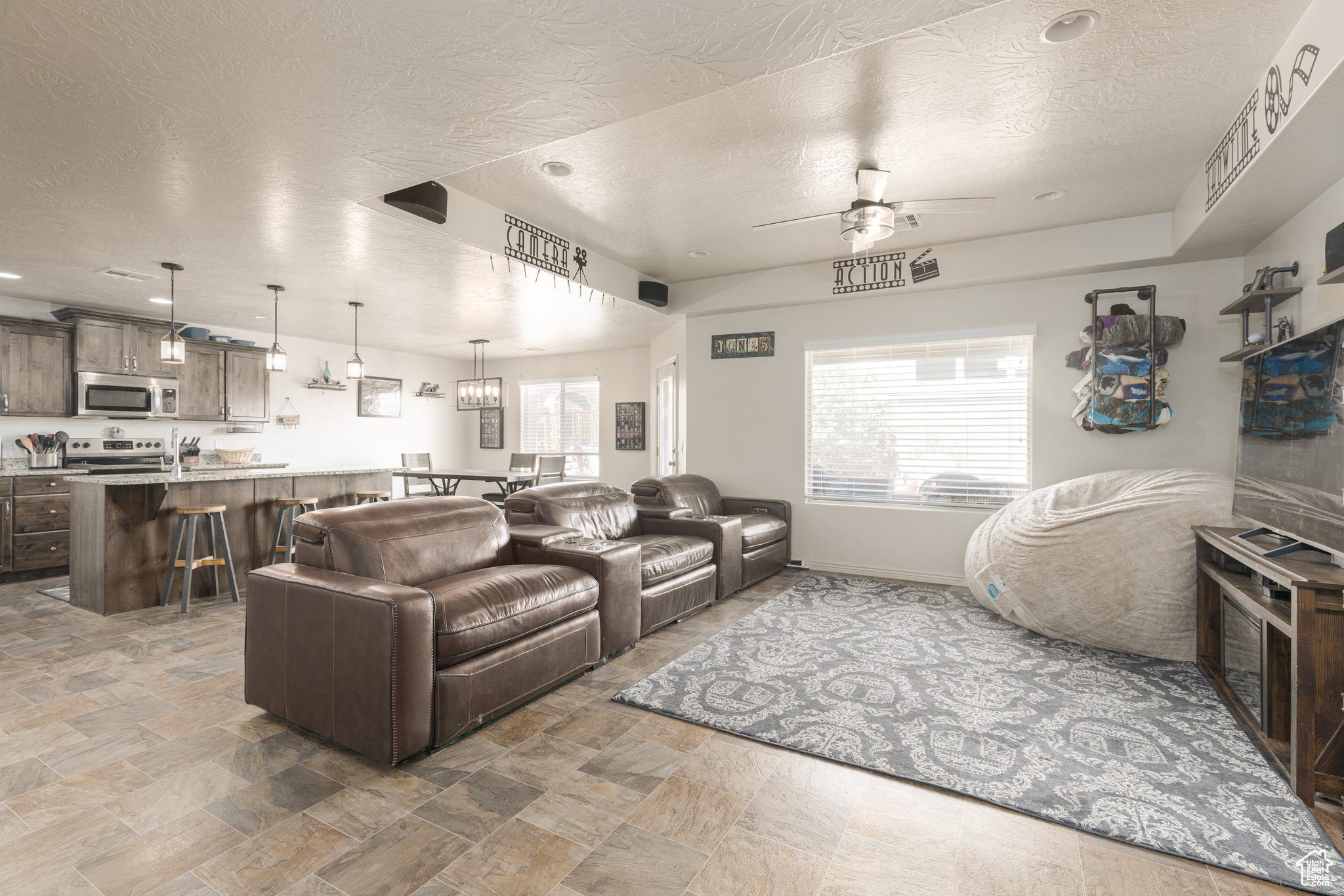 Tiled living room featuring a textured ceiling and ceiling fan